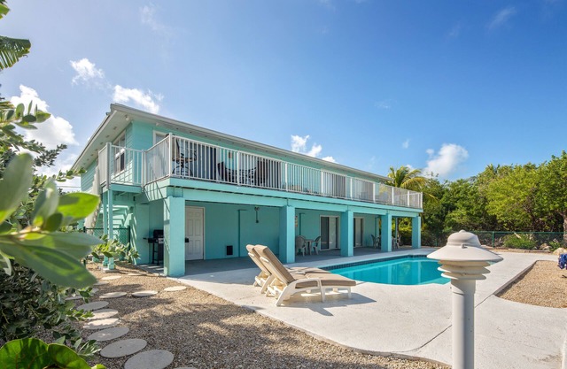 Canal-front, dog-friendly home with heated pool, seawall dock & grill