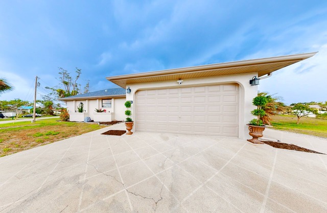 Canal-front home with private dock, pool, screened lanai, & W/D