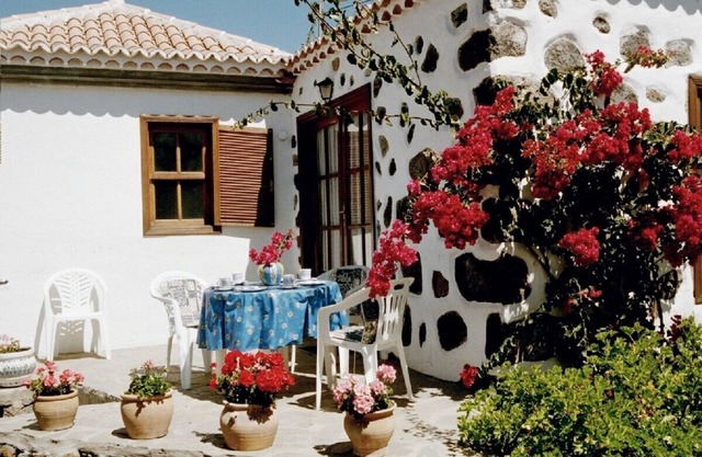 Canary Island style house with stone walls, surrounded by a terrace