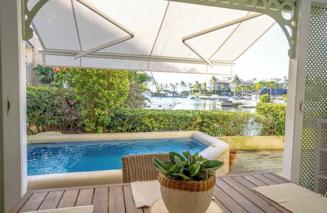 Charming 2-brm WATERFRONT Villa with WiFi, AC, & Pool in PORT ST CHARLES MARINA!