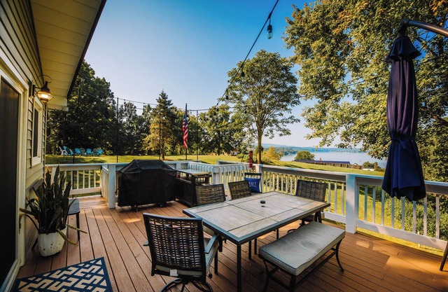 Charming lakeside retreat with serene views, cozy interiors, spacious deck, and lush outdoor spaces.