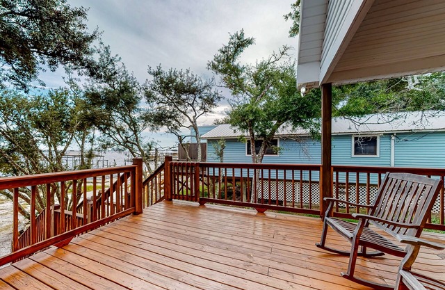 Charming waterfront home with lovely views, grand deck & inviting interior