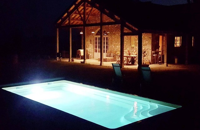 Country house with pool among sunflowers
