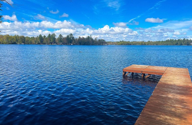 Dog-friendly lakefront property with dock, boat lift, firepit, & two kitchens