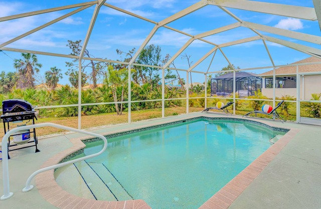 Dog-friendly single-story home with heated private pool, lanai, firepit & golf