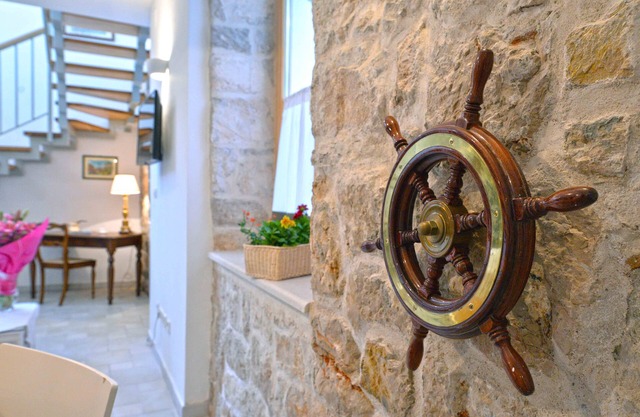 Frantoio House. Charming stone house in front of the dock