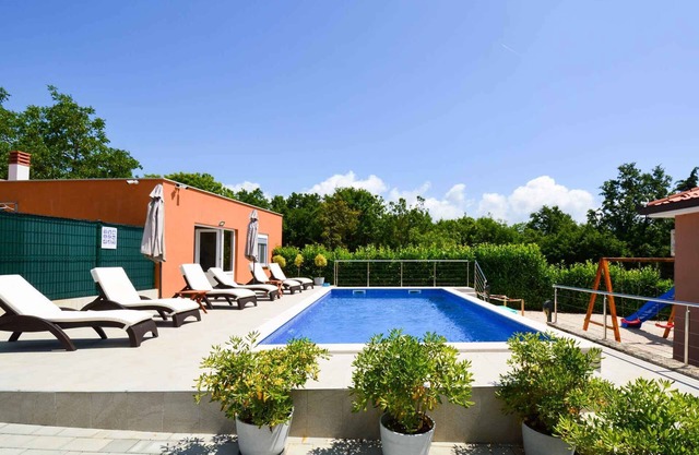 Holiday home with pool and children's playground