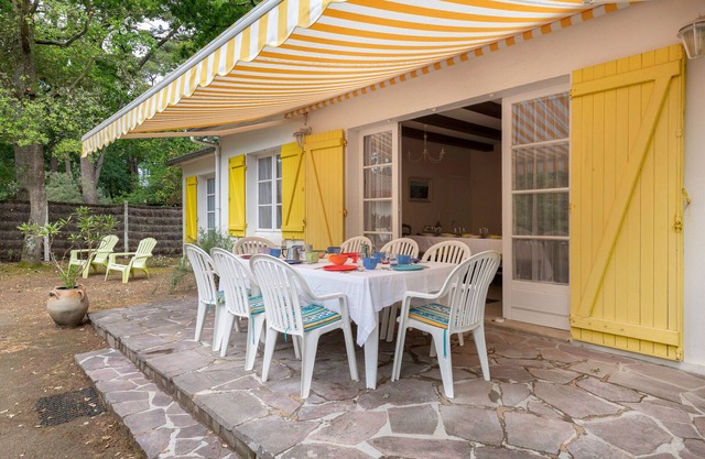House between pine trees and beach