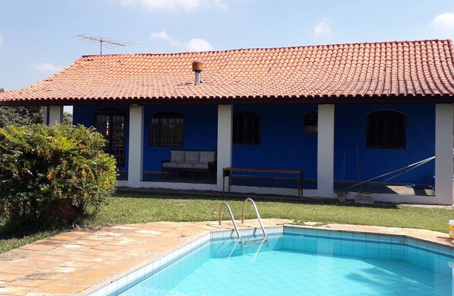House in fenced area, with pool, barbecue, field and parking.