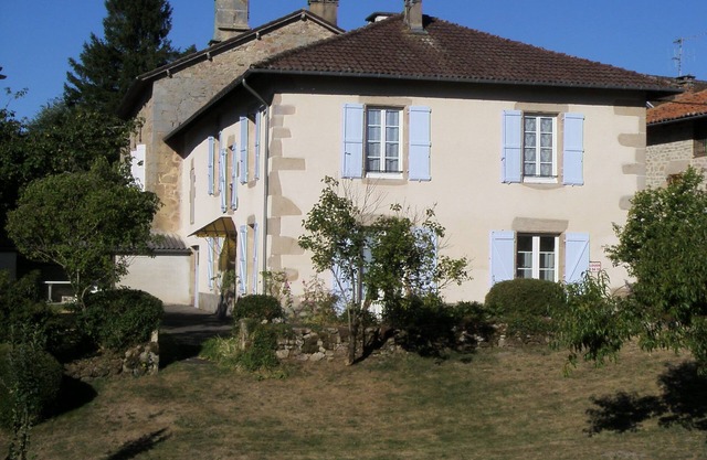 House with fenced garden in village