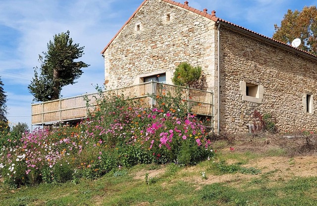 In a rural location, this tasteful stone house welcomes you.