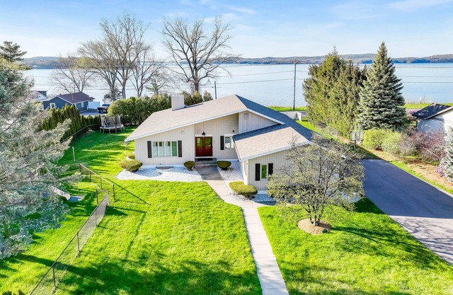 Lakefront home with pool, beach access, central AC, washer/dryer, & fireplace