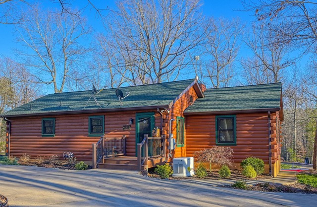 Lakefront living with direct beach access, two docks, boat house, firepit, & bar