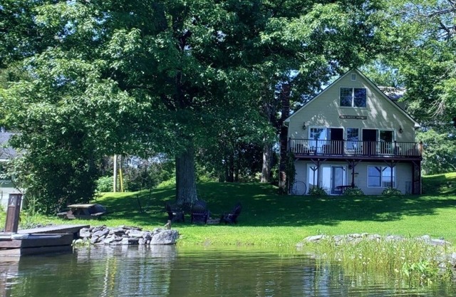Lakeside house on Webber Pond with a small beach and stunning, peaceful views.