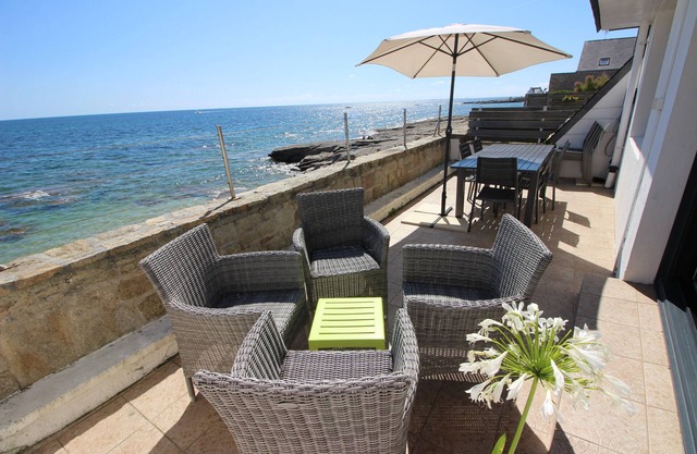 Large house facing the sea, feet in the water