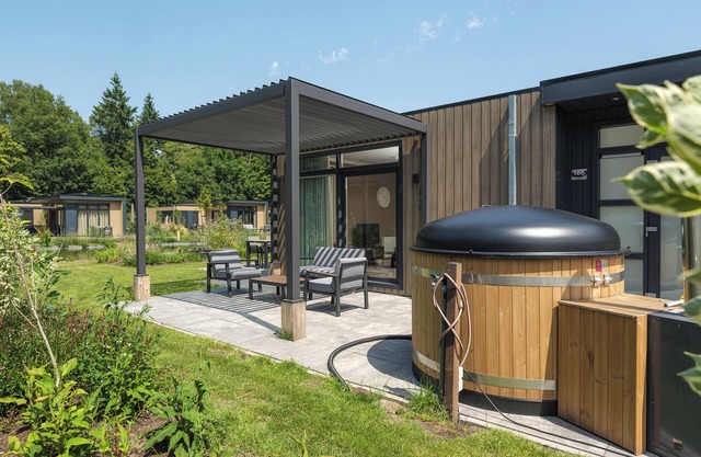 Luxury Batenburgh Deluxe with hot tub. Enjoy a hot tub, atmospheric outdoor space, and a lounge area with an outdoor fireplace.