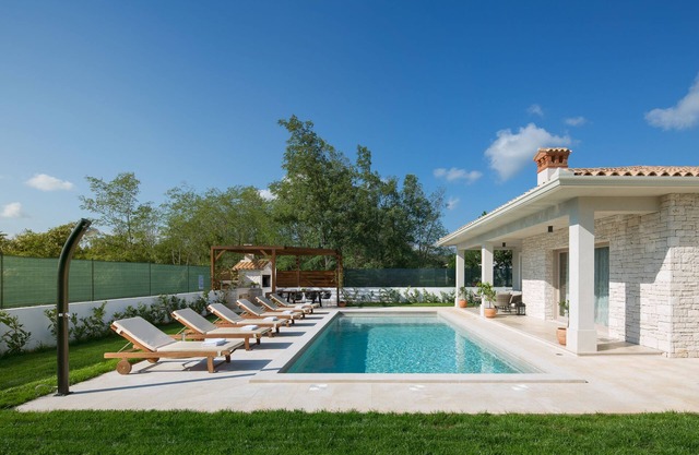 Mediterranean villa with large private pool and garden, ideal for relaxing.