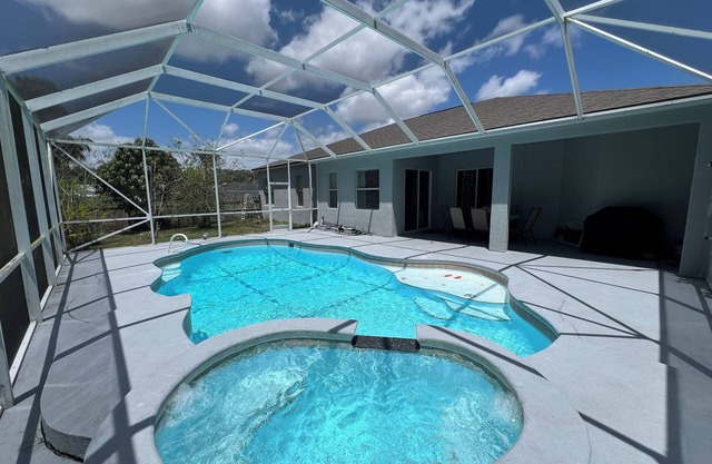 Modern and spacious getaway with a pool and grill