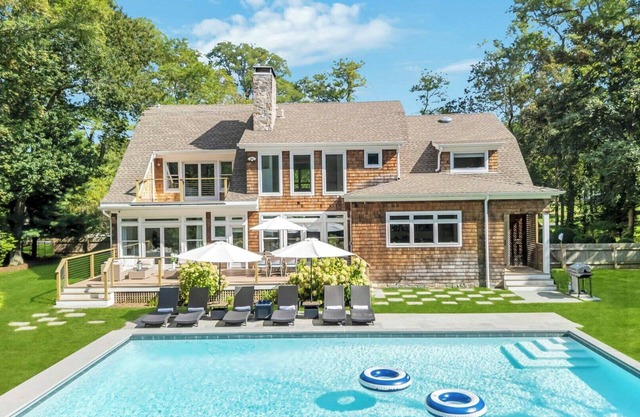 Modern Coastal Farmhouse style home with a private pool, open-floor plan,.