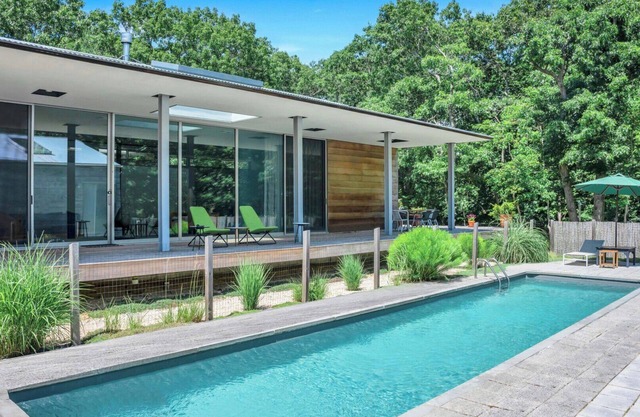 Modern home sited on a lush wood acre, stunning pool, covered deck, outdoor.