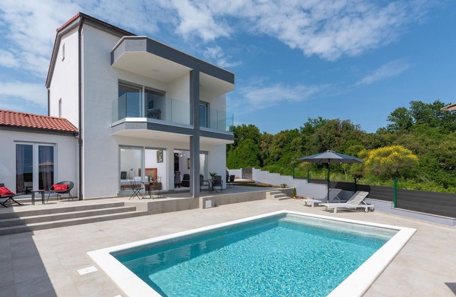 Modern vacation home with pool and sea view.