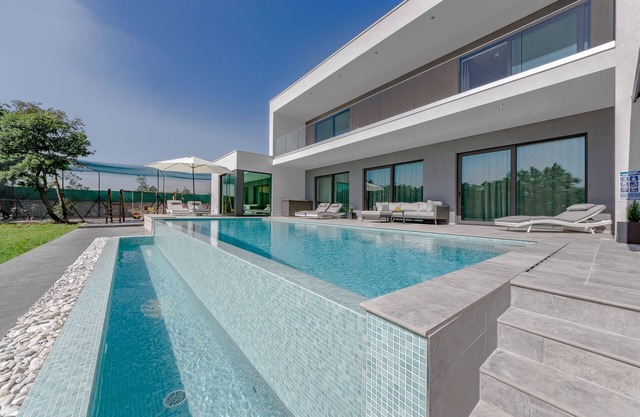 Modern villa with infinity pool, playing field and free e-charging station
