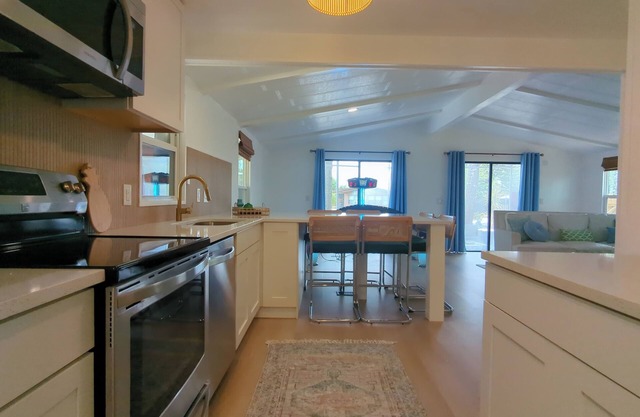 Newly renovated home with air hockey, games, huge TV wall,fenced yard+screenroom