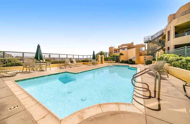 Ocean Pointe Getaway Coastal condo with ocean-view pool, private patio, grill, & AC - walk to beach