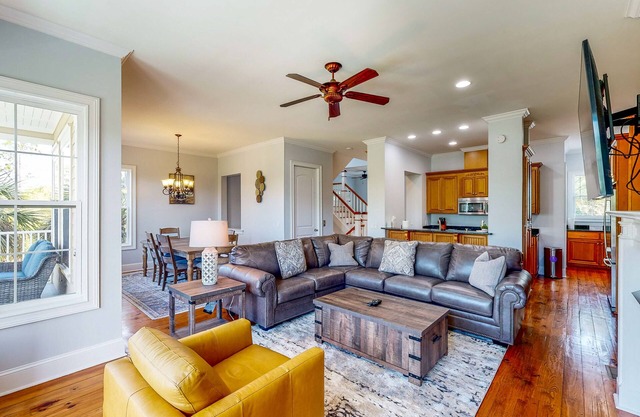 Palm-lined home with dock access, firepit & inviting balconies