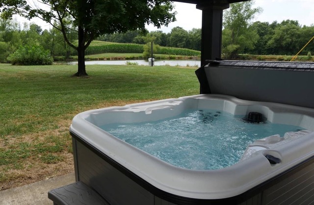 Relax at a cozy countryside retreat with a private hot tub, pond views & fire pit — pure bliss.