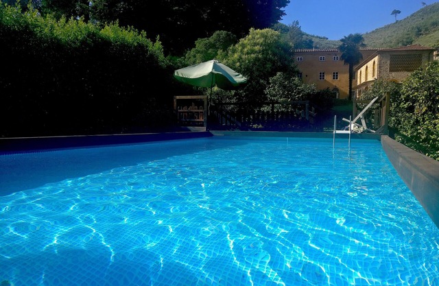 Restored barn with large pool and mountain stream