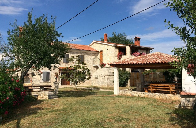 Rustic farmhouse surrounded by the greenery of the large and spacious garden . with swimming pool