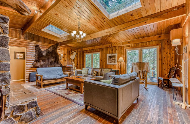 Rustic lodge with private hot tub, fireplace & riverfront views - dog-friendly