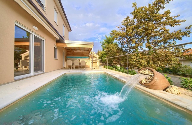 Seafront apartment Jana with heated swimming pool