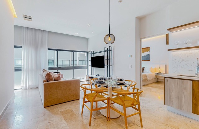 Sleek apartment with walk-in showers, central AC, plunge pool, and ocean views