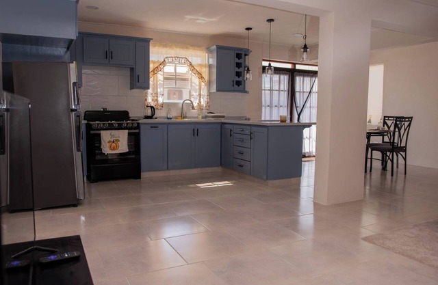 The apartment features an open plan living and dining area, and a spacious and modern kitchen.