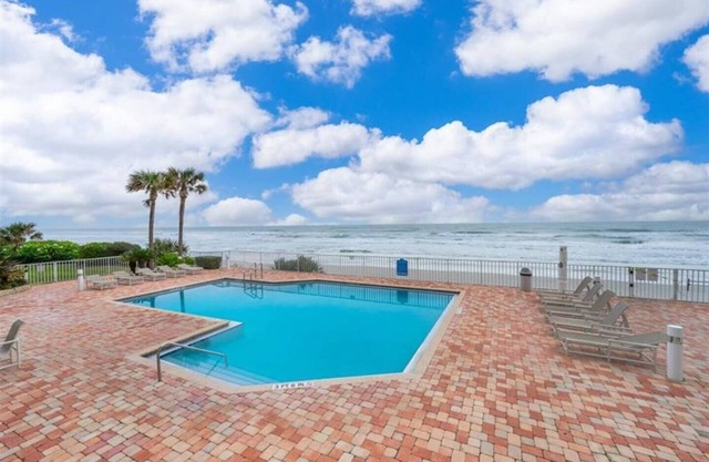 This stunning oceanfront 2BR condo in peaceful Ponce Inlet offers breathtaking beach views. Relax on the wraparound balcony with your morning coffee as pelicans glide by and dolphins surface in the waves below.
