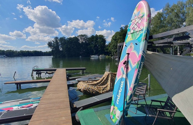 Tiny house with outdoor chimney and an own water jetty at the lakeside.