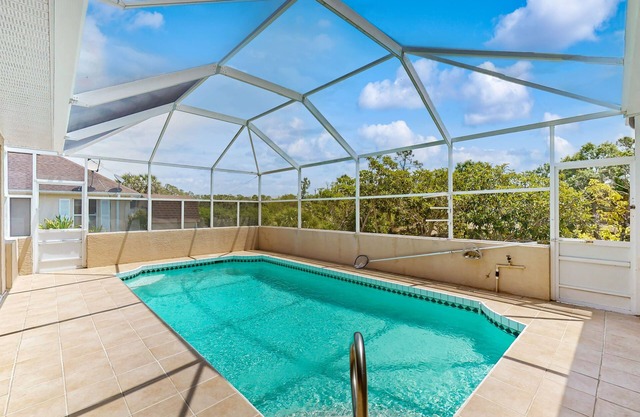 Tropical home with in ground pool and large private backyard