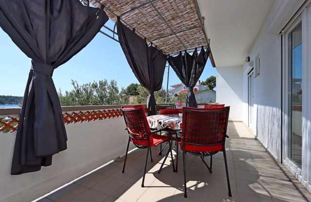 Two bedroom apartment with terrace and sea view Barbat, Rab (A-14247-a)