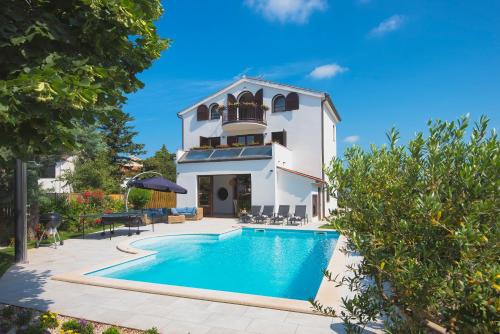 Villa Andrija Family Dream with heated pool at the sea with beautiful garden, outside cinema and kids playground