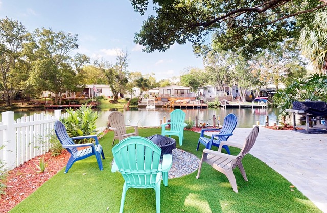 Waterfront home with amazing yard, firepit, grill, putting green, AC, & W/D