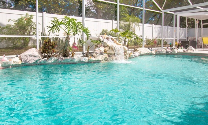 Chatham Park House | 3 Bedroom Home with Private Screened Pool with Rock Waterfall Feature and Gameroom by Florida Dream.