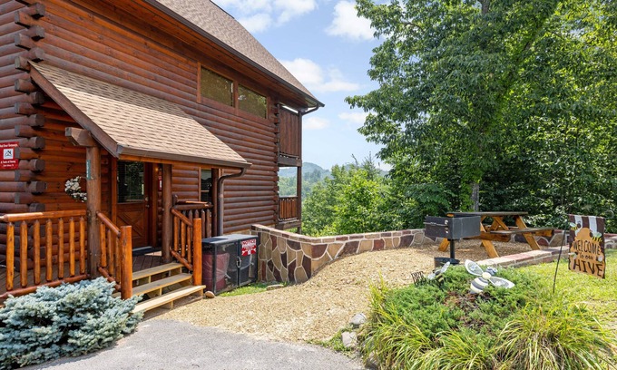 Gatlinburg - Pigeon Forge Cabin | A Taste Of Honey is a dog-friendly two-bedroom true-log cabin nestled inside the Starr Crest resort.