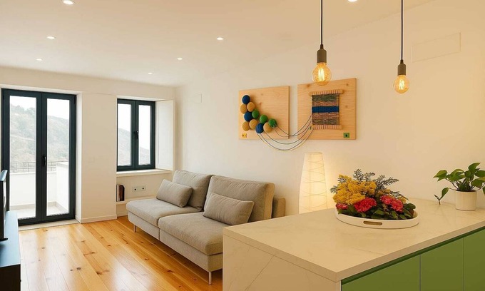 Covilha Apartment | Apartment in the former working-class neighborhood linked to the wool industry. The bright living room and decor featuring burel pieces evoke the city's history. A fully equipped kitchen, two comfortable bedrooms, and ensure an autentic stay.