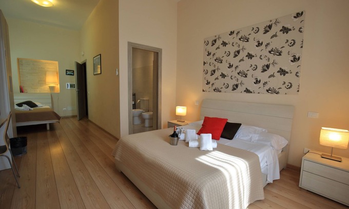 Esquilino Bed & Breakfast | Aria Rome Rooms triple room with balcony view of Basilica di San Giovanni