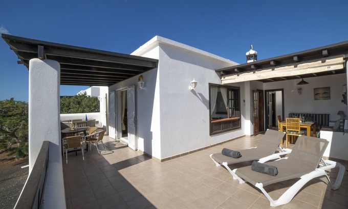 Playa Blanca Villa | Blue Heron Property with a Hot tub and 5 minutes walk to the Sea front Promenade