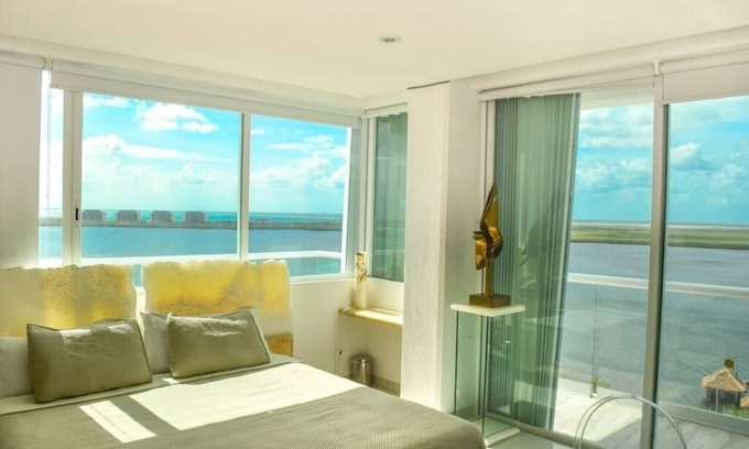 Zona Hotelera Condo | breathtaking studio, w/ocean and lagoon views, amazing wrap around balcony,.