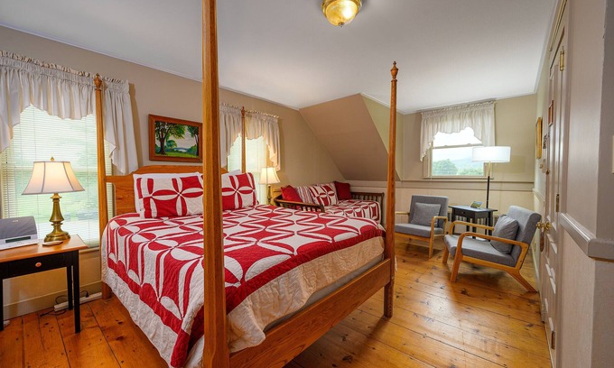 Stowe Bed & Breakfast | Comfortable room with queen bed and daybed with windows on 3 sides, a stunning view of Mount Mansfield and a parlor stove with full service breakfast included