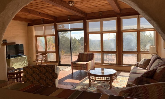 Tyrone House | Escape a cold winter in our large passive solar adobe home with 4 gentle seasons